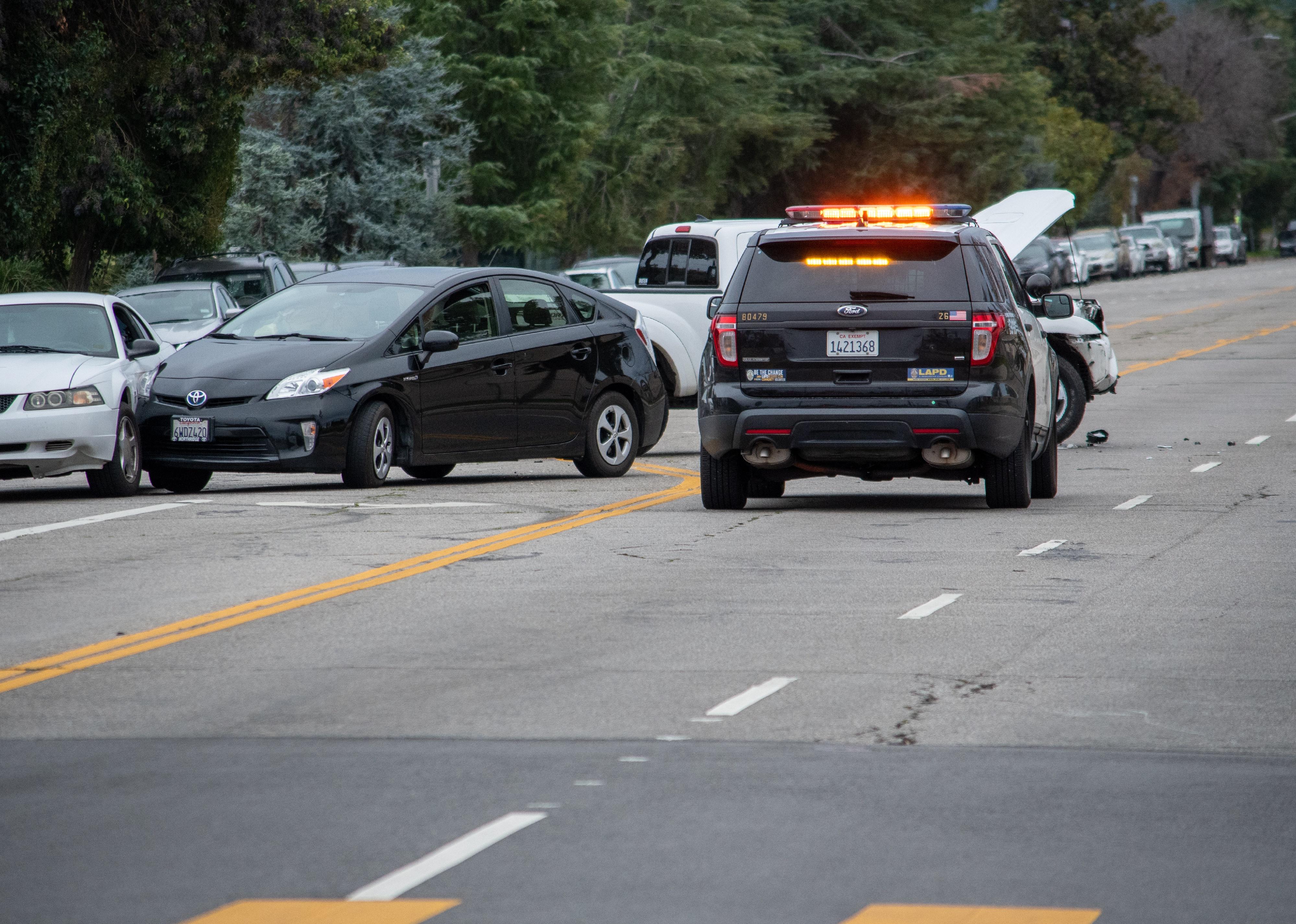 Traffic patrol vehicle sits in the middle of the road at a traffic accident investigation.