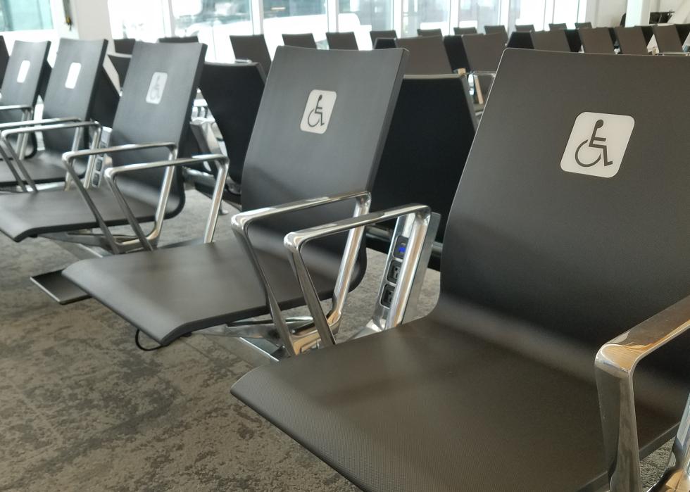 Chair seats in an airport waiting area marked for passengers with disabilities