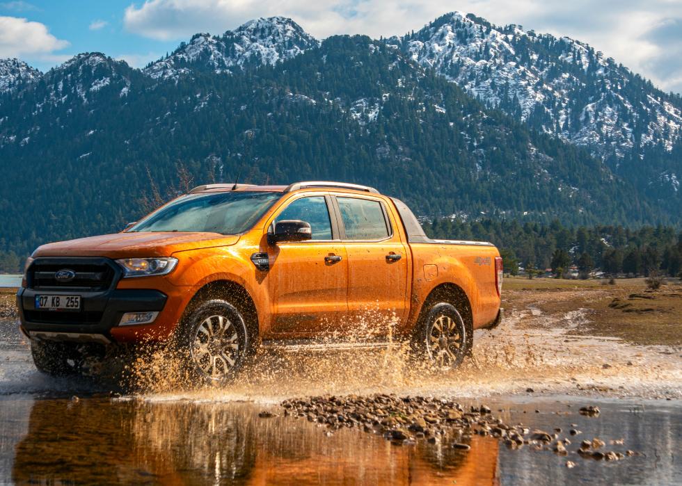 Ford Ranger truck off roading in the mud of a river