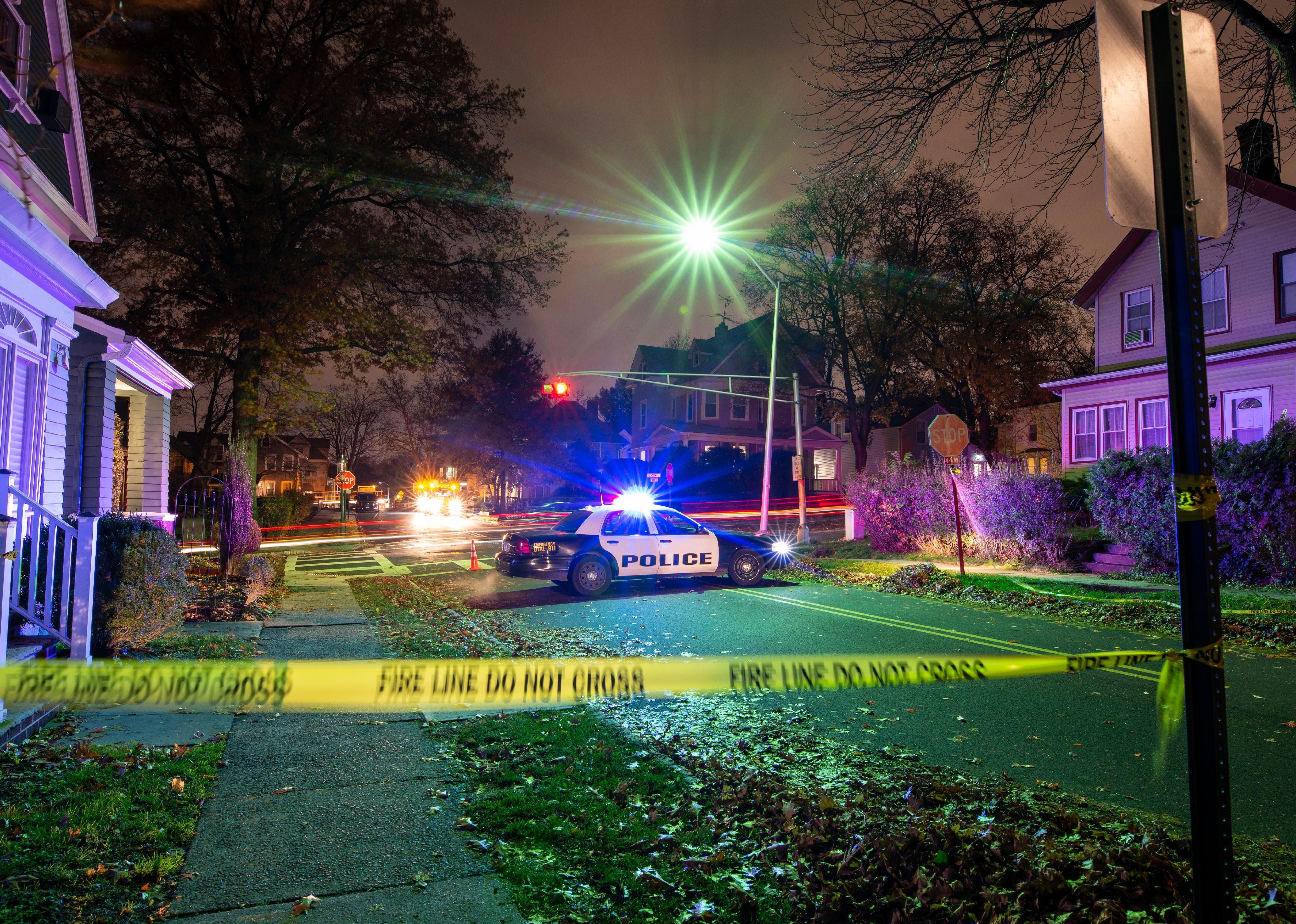 Crime scene with tape and police car.