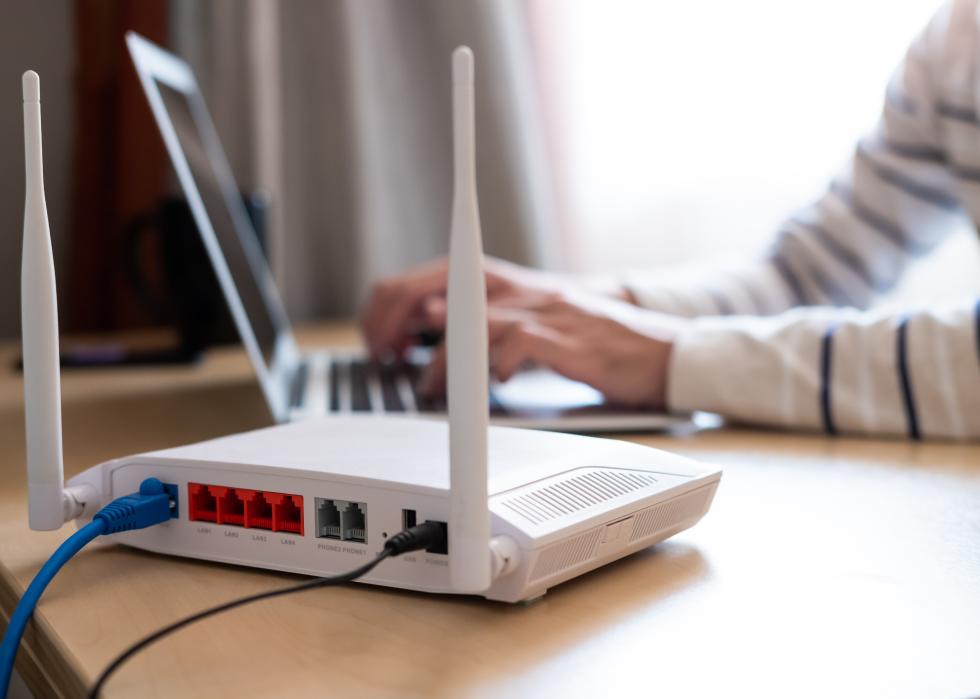 Internet router on working table with blurred man