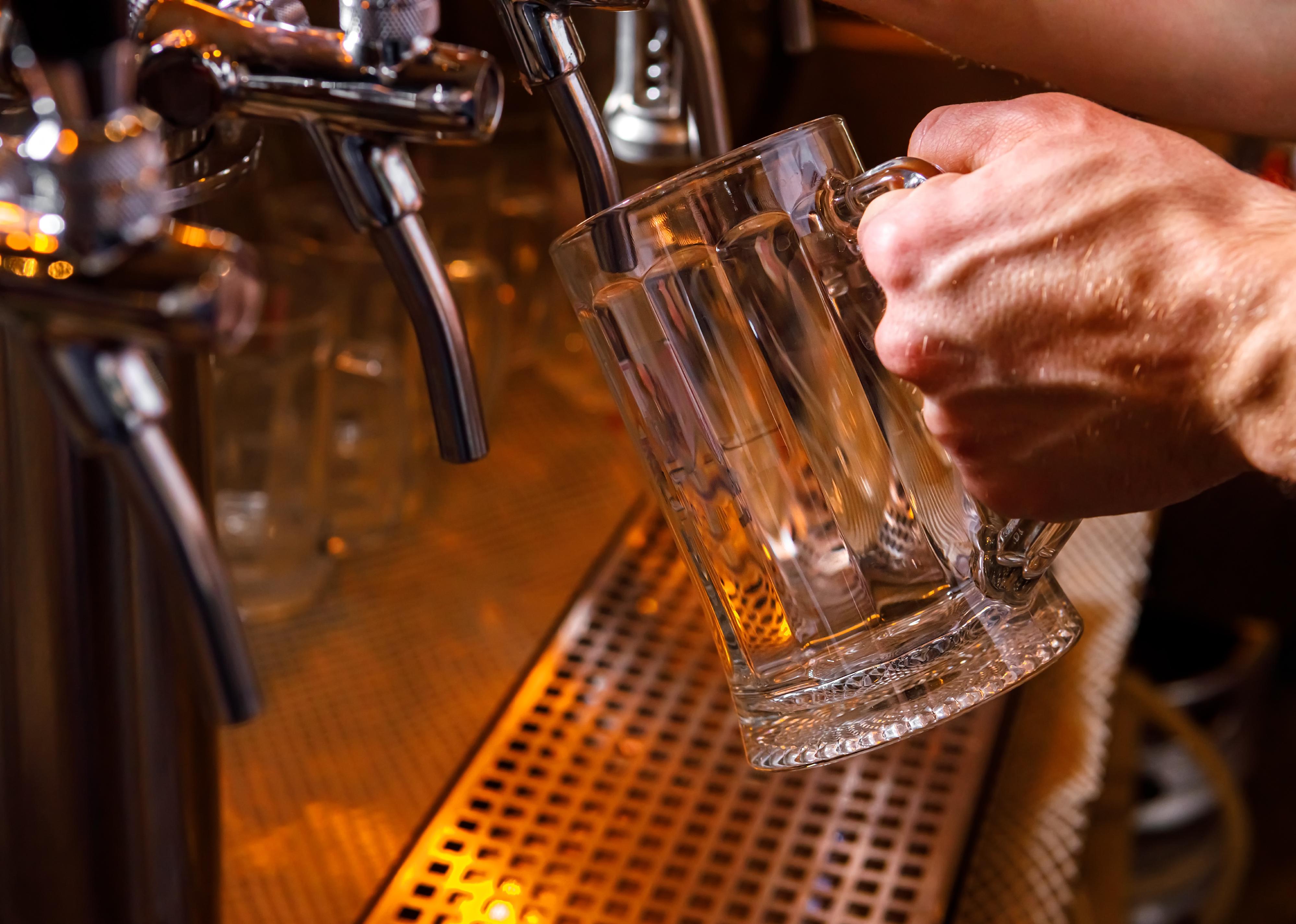 Pouring beer into a mug in a beer bar close-up