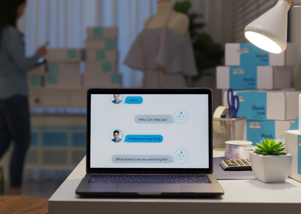 Chatbot conversation on laptop screen with artificial intelligence providing customer support.