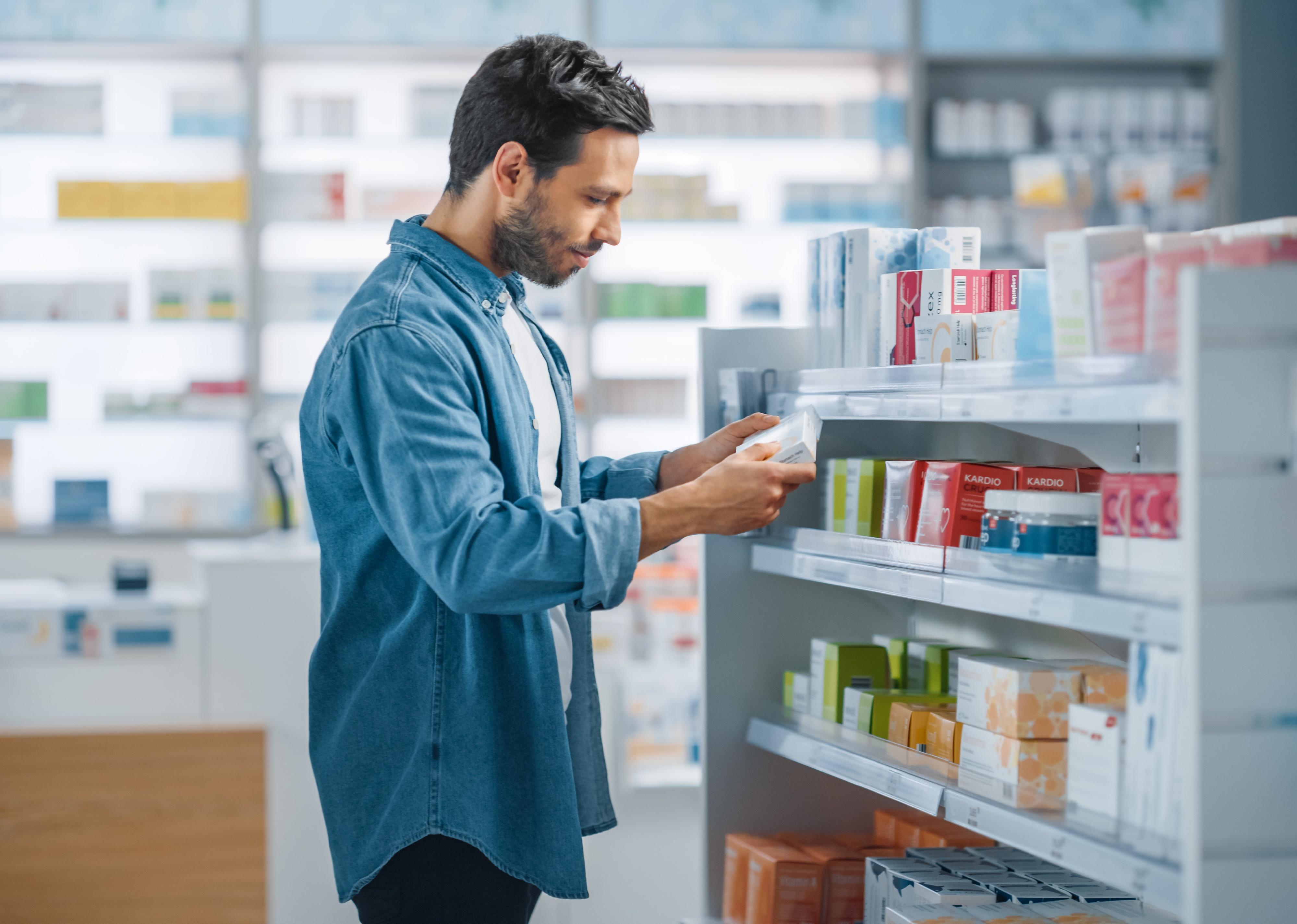 Man looking at medicines in drugstore.