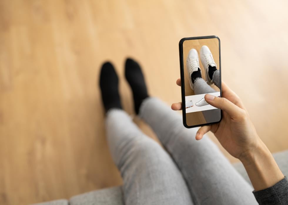 Woman trying virtual shoes through AR store app
