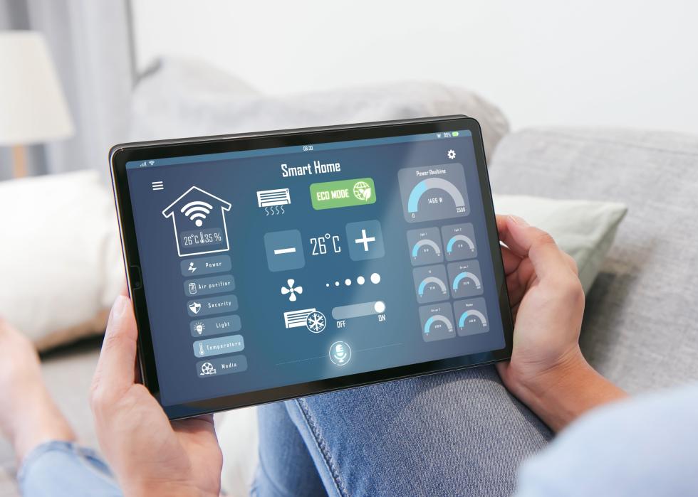 Rear view of woman with smart home tablet