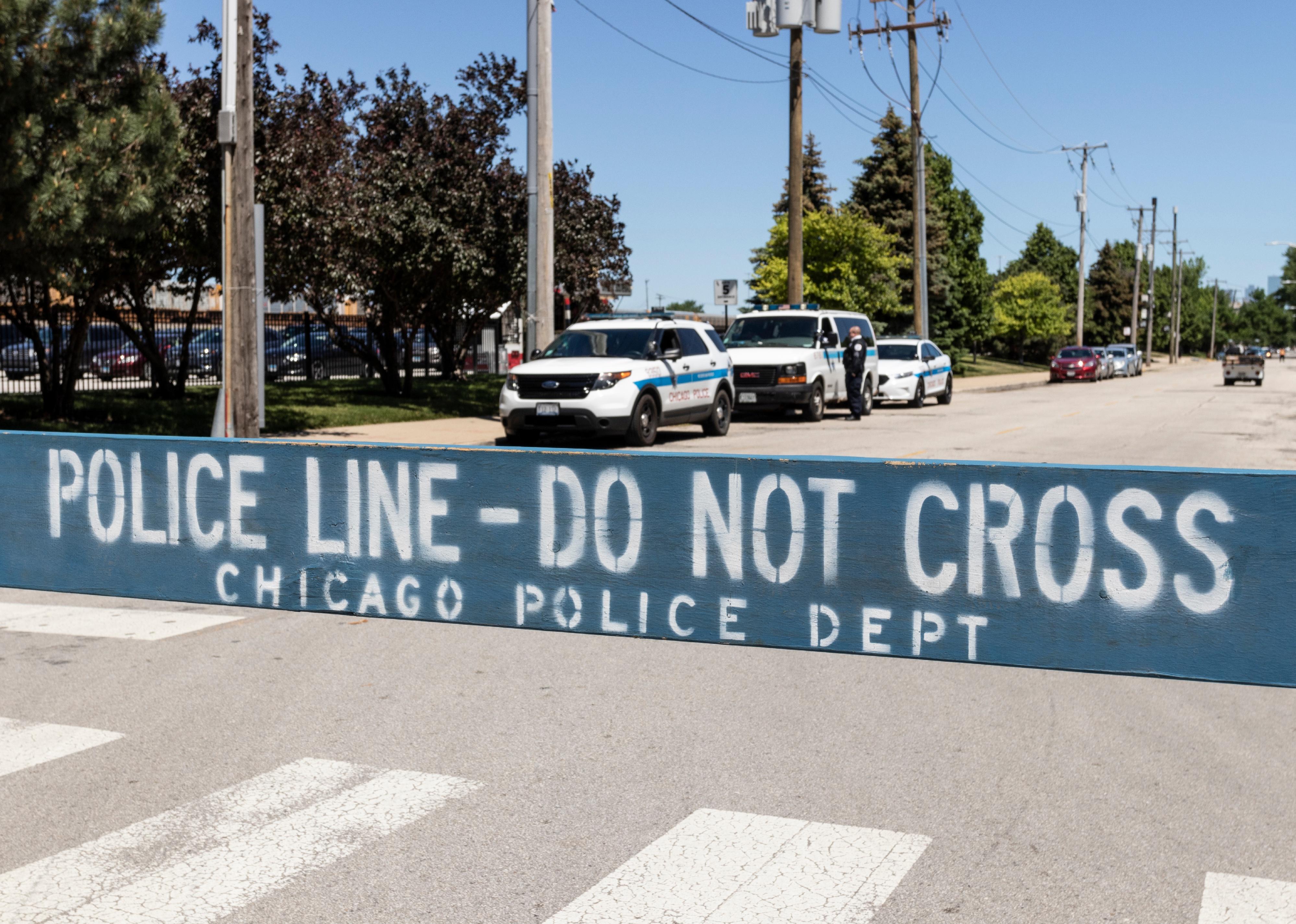 POLICE LINE DO NOT CROSS sign courtesy of the Chicago Police Department.