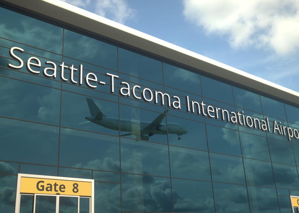 Commercial plane landing reflecting in the windows with seattle-tacoma international airport