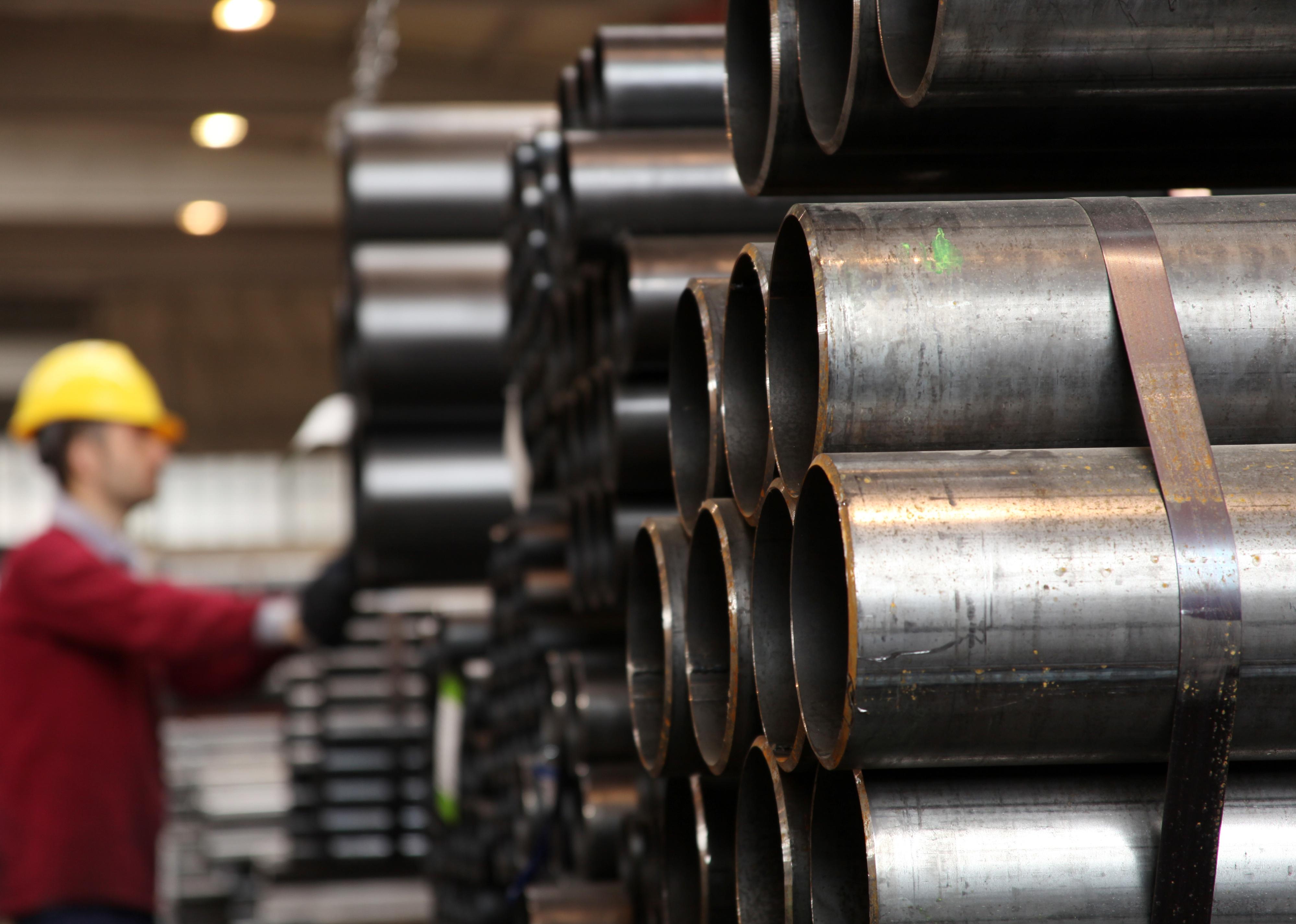 Steel pipes in a stack in a manufacturing plant.