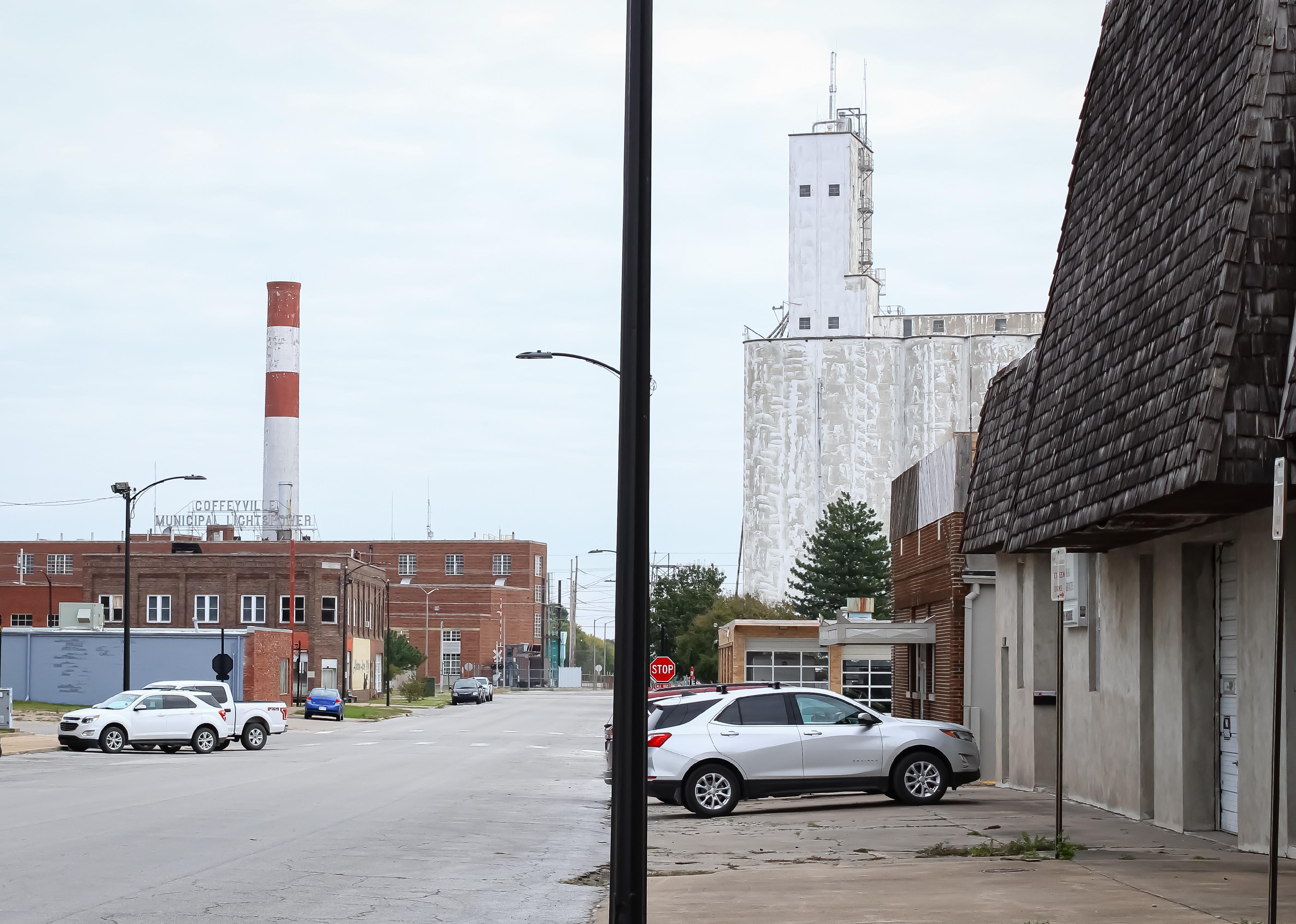 The townscape of Coffeyville with a grain elevator and a power plant.