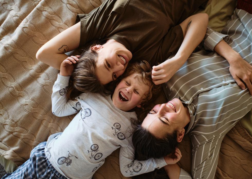 Happy family with child on bed