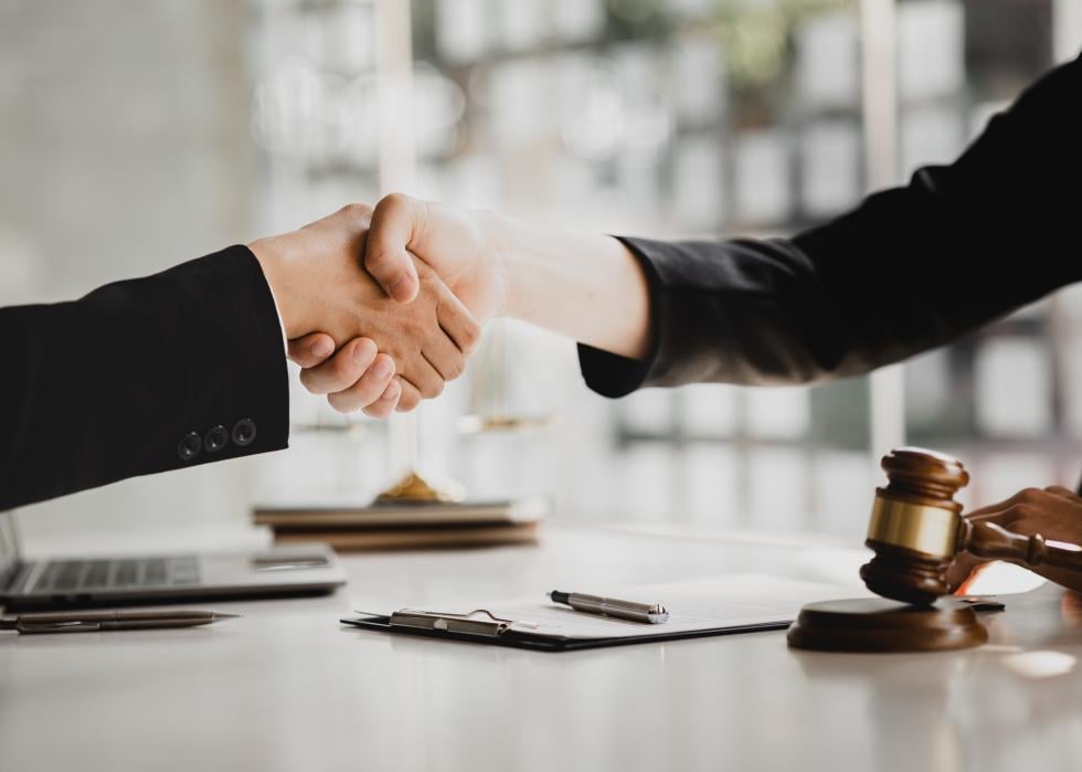 Lawyer and client shaking hands.