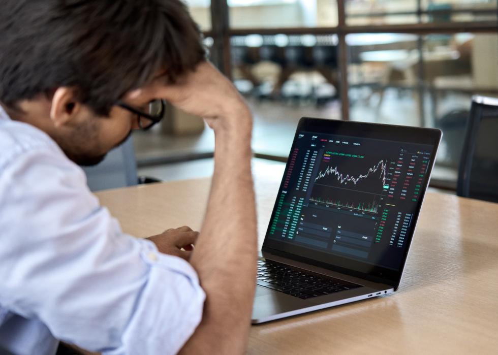 Stressed crypto trader at computer