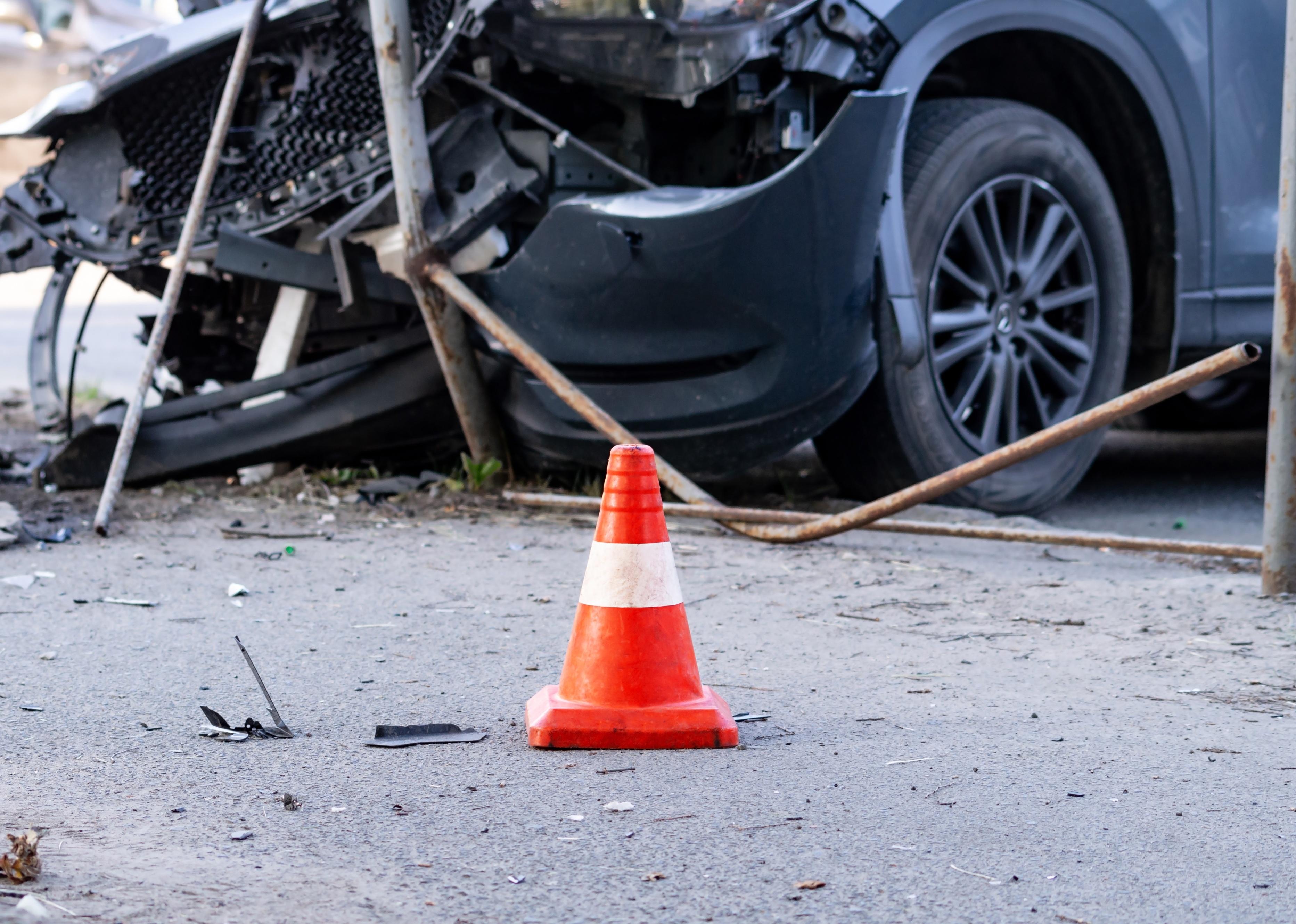 Road cone against the background of a car crash.