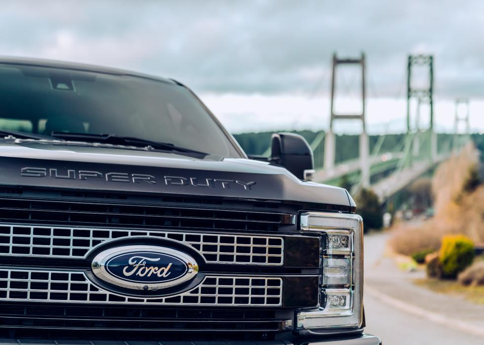 Ford F350 parked with a bridge in the background.