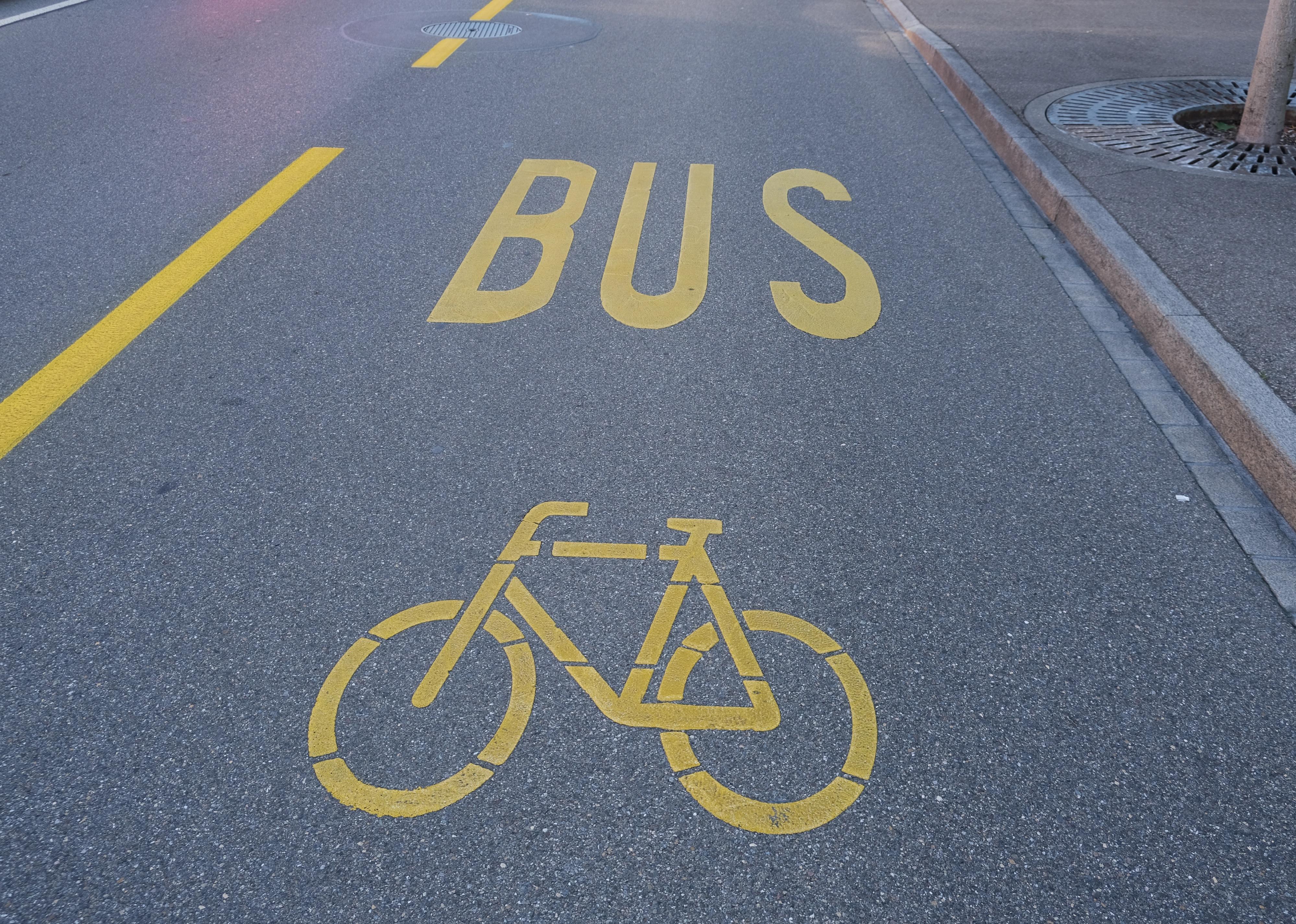 A close up bicycle and bus lane painted sign on the road