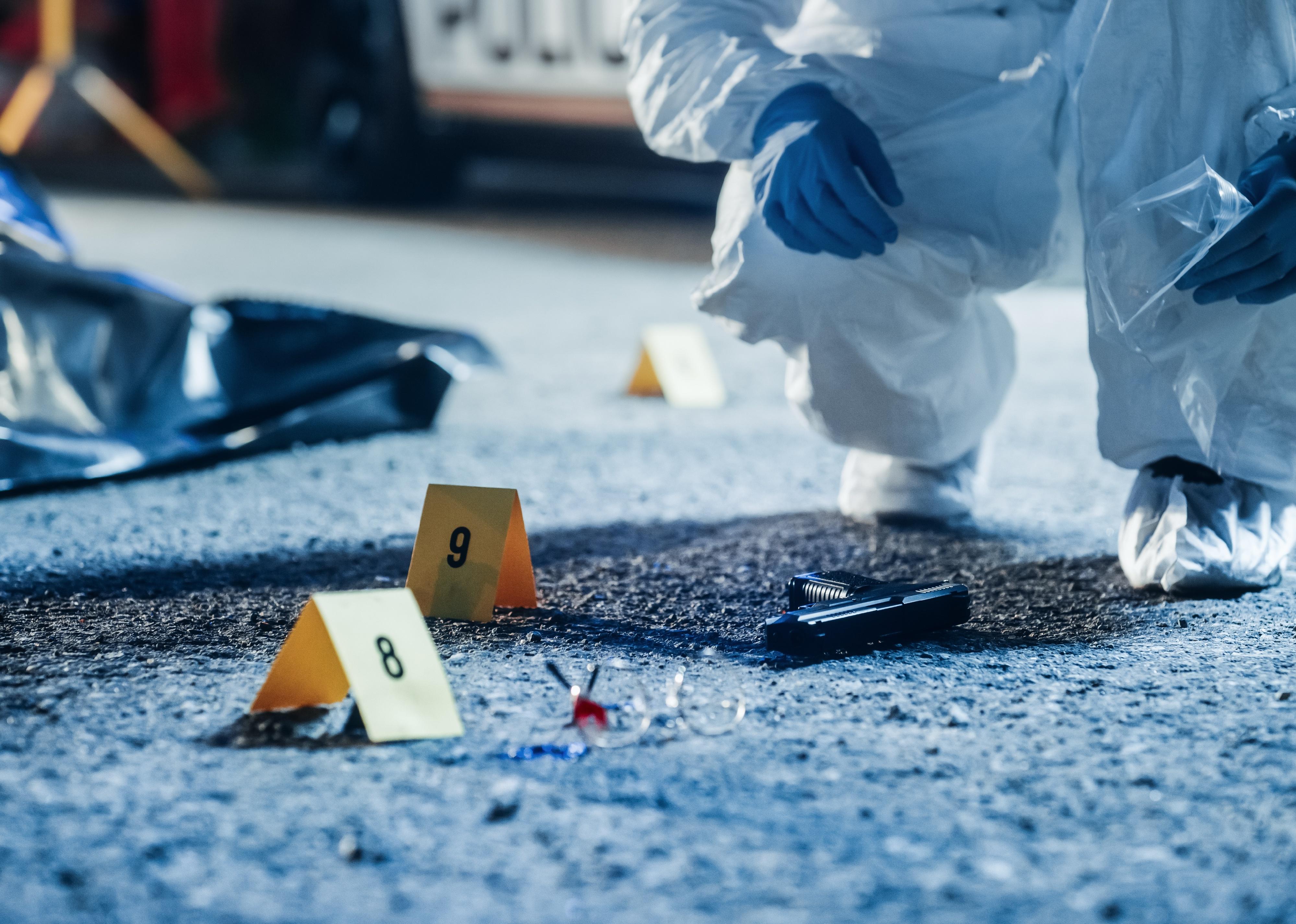 Gun and other evidence at a crime scene.