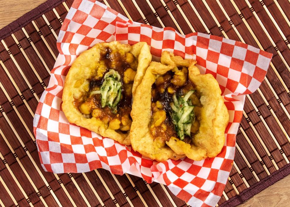 A snack of curry chick peas in bara fried dough.