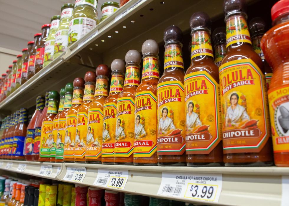 Several bottles of Cholula hot sauce on display at a local grocery store.