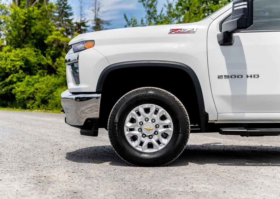  A white Chevrolet Silverado pickup truck parked on a grassy lot.