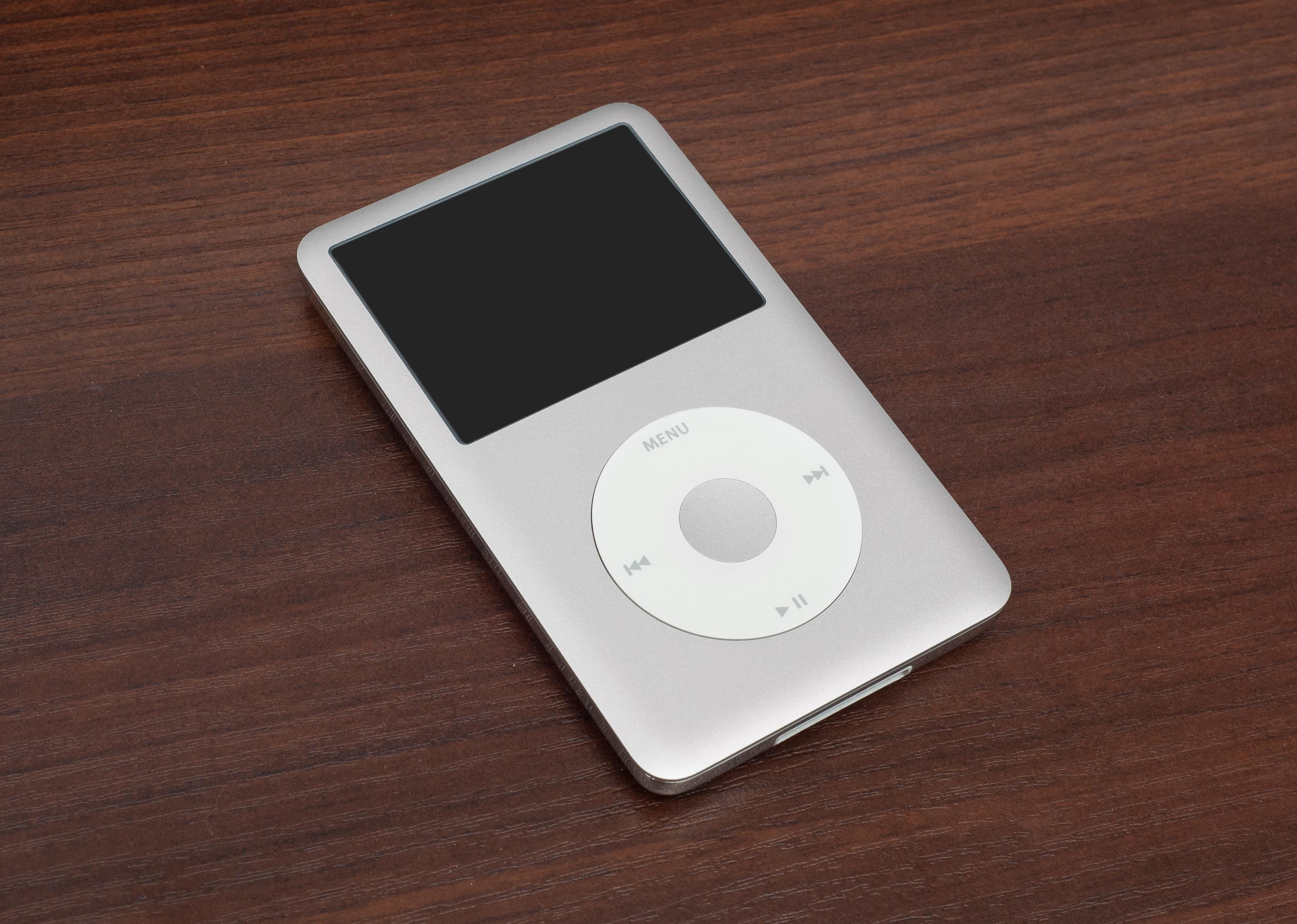 iPod Classic on a wooden table.