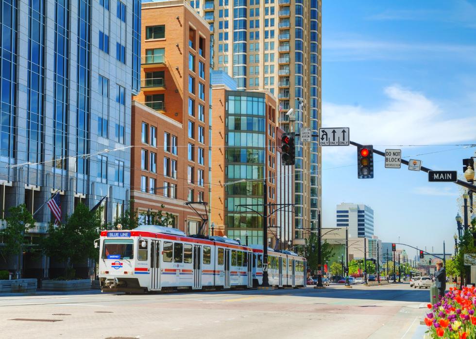 A light rail train travels down a Salt Lake City street.