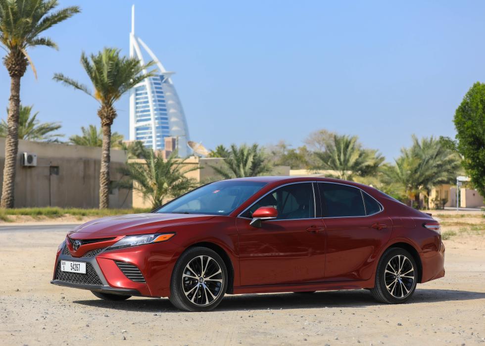 Toyota Camry Hybrid on a dirt lot.