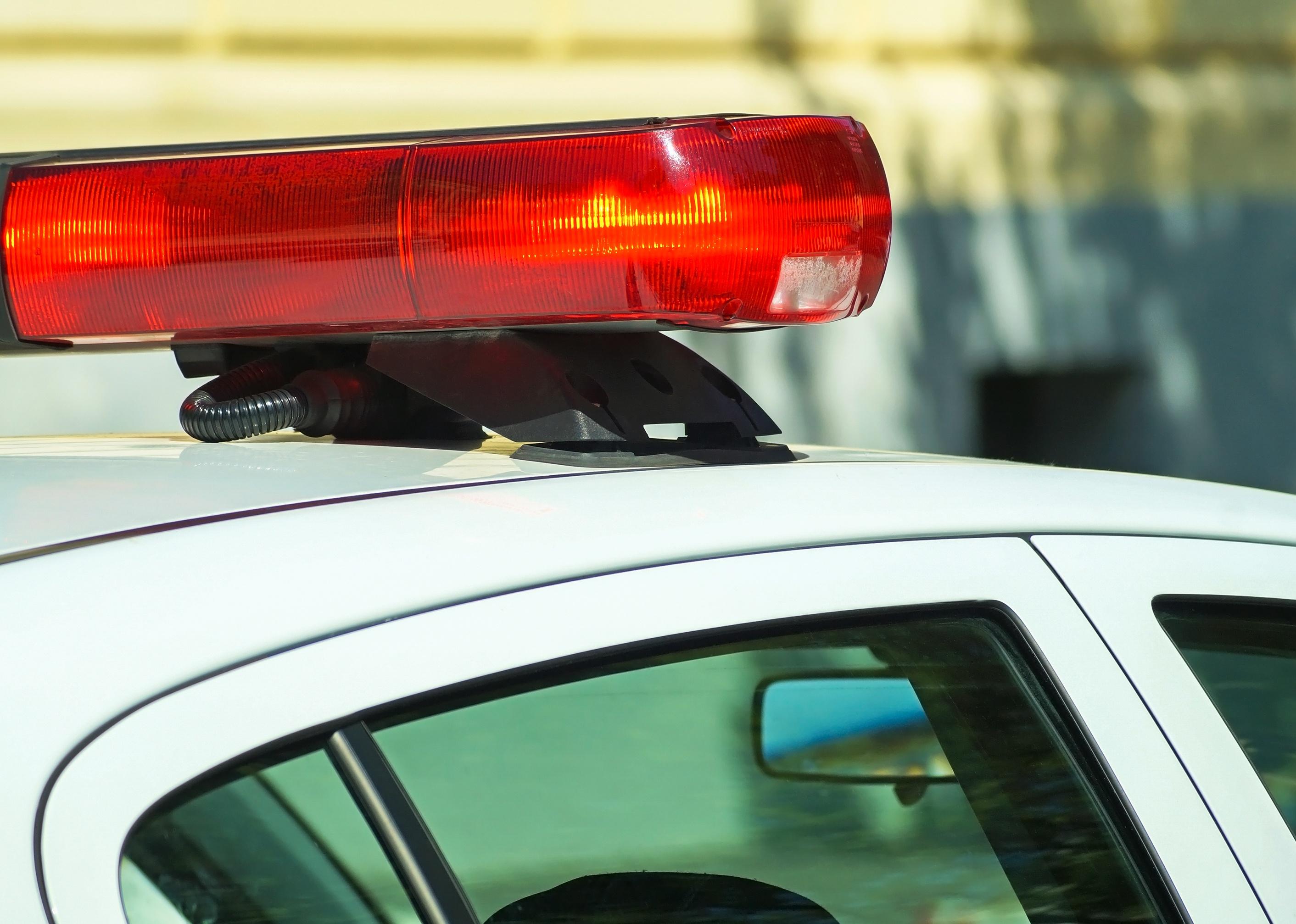 Close-up of red light on police car.