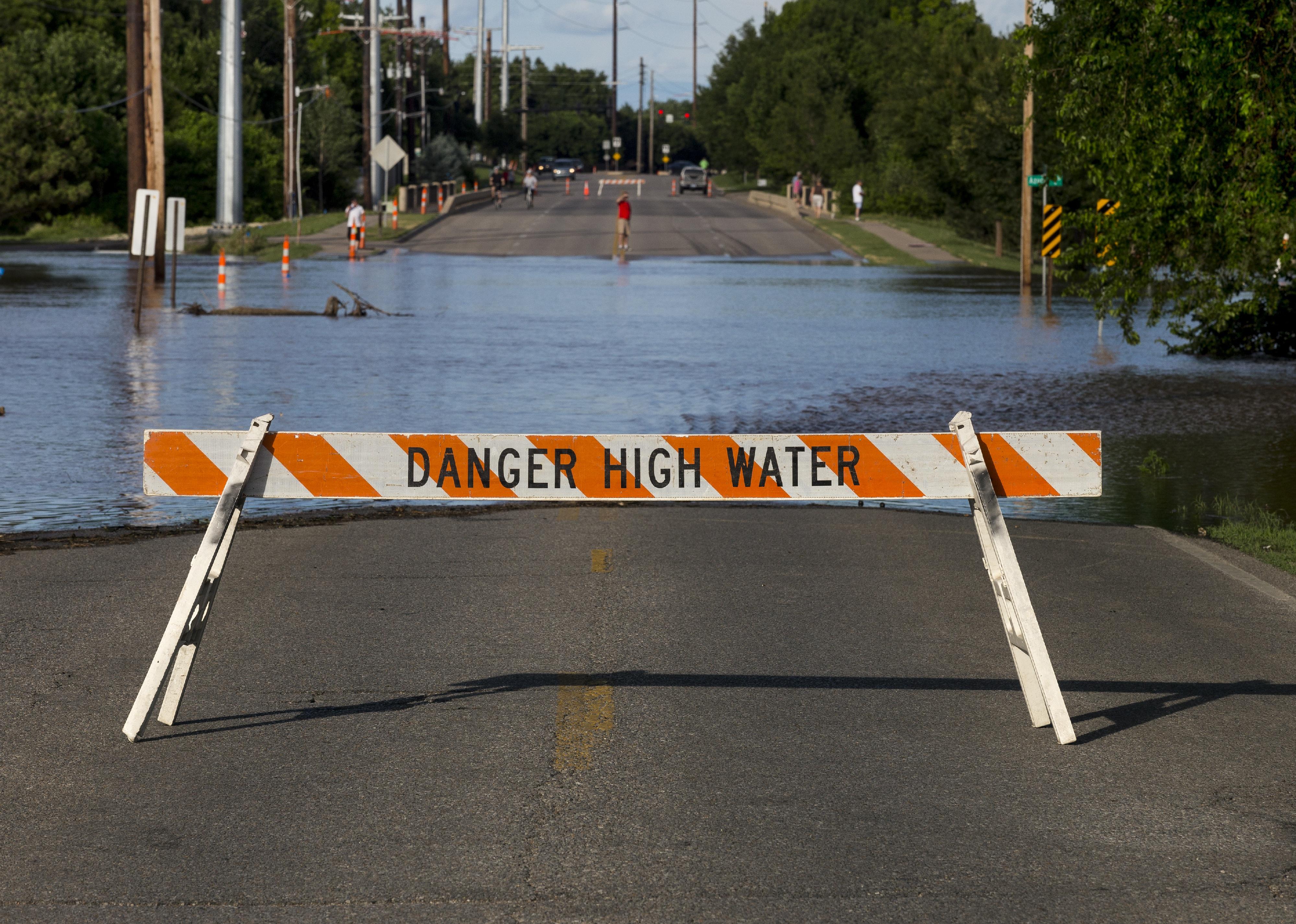 Maple Street closing due to Cowskin Creek flooding.