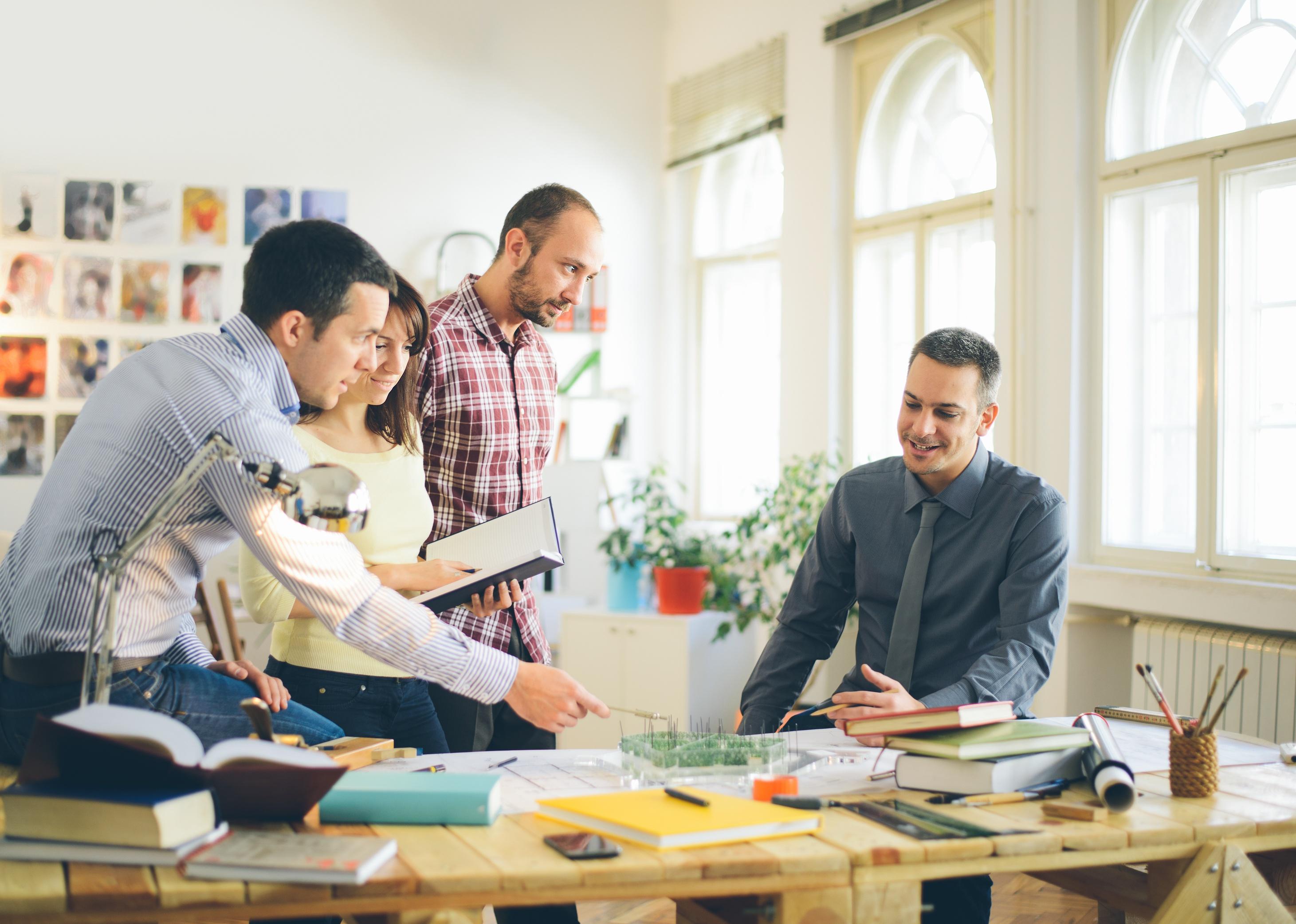 Group of young architects working in an office.