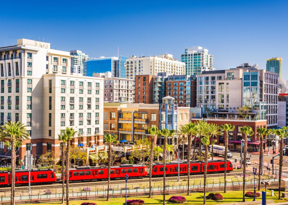 The light rail San Diego Trolley moves along a downtown street.