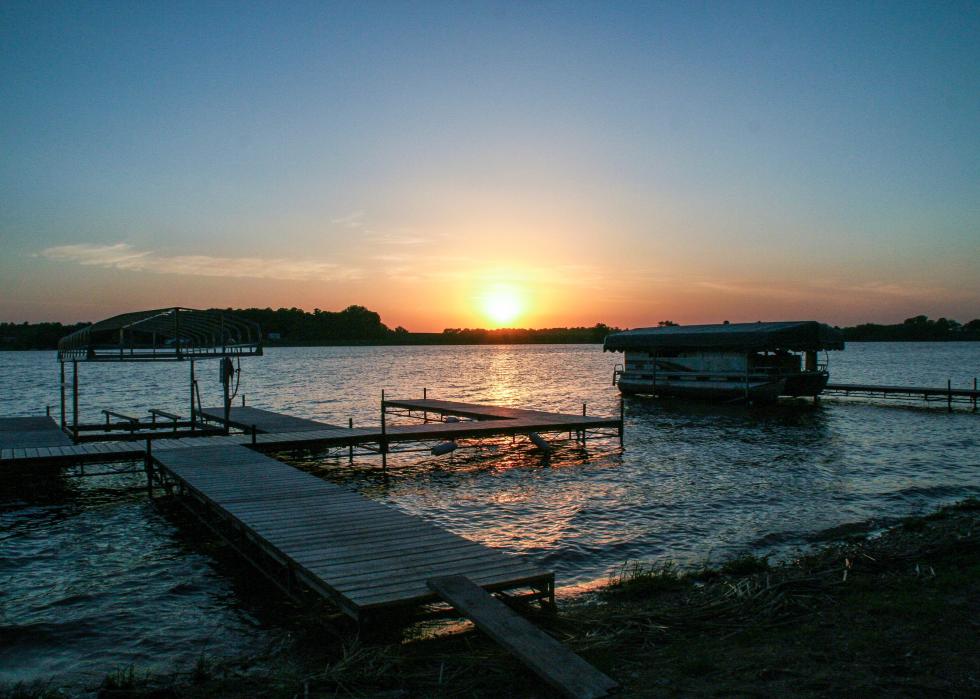 Sunset on a dock with pontoon boat on Lake Reno.