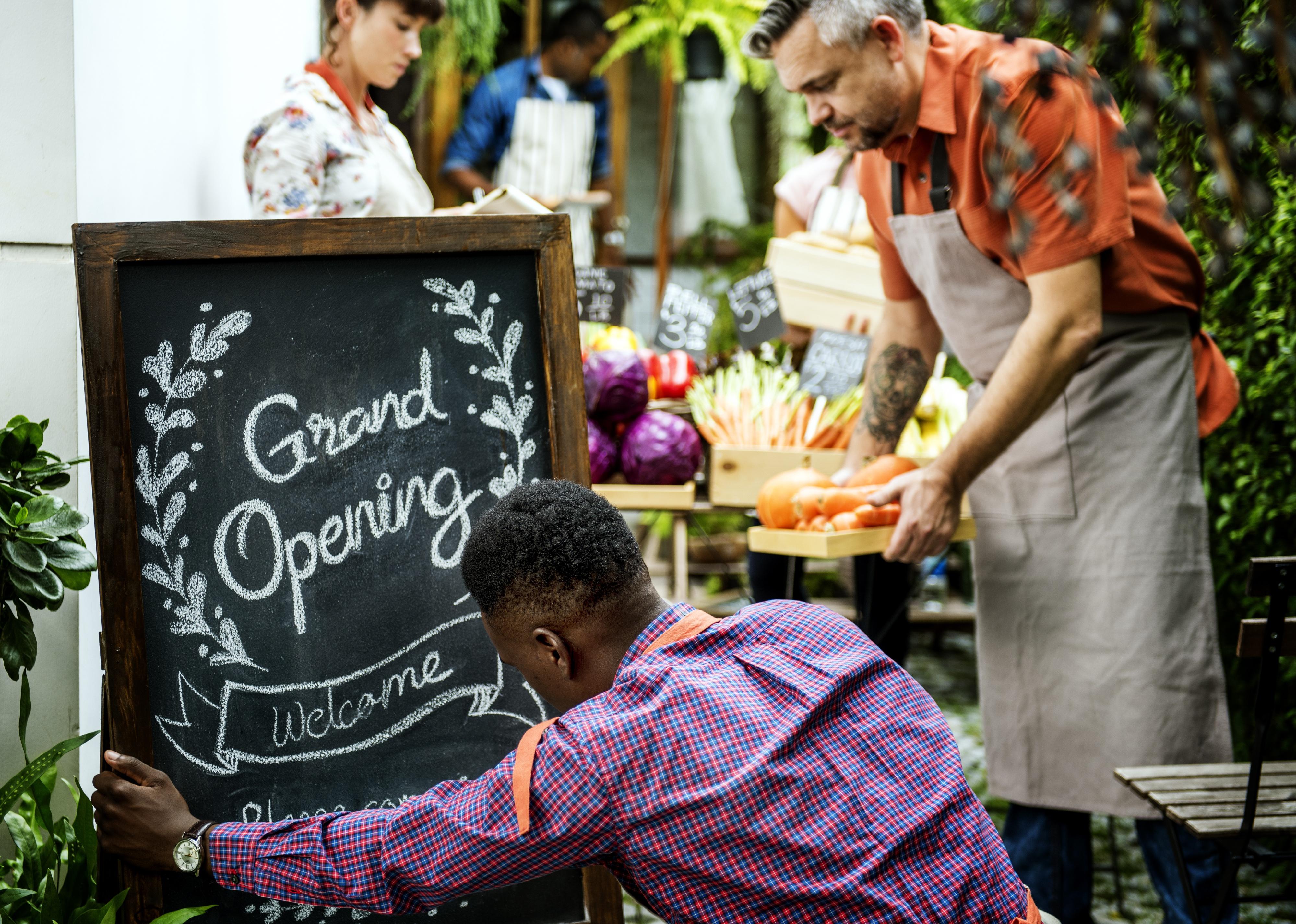 Man setting up chalkboard sign.