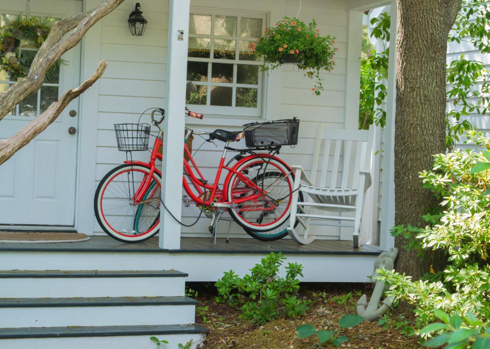 View of a red bicycle on a front porch.