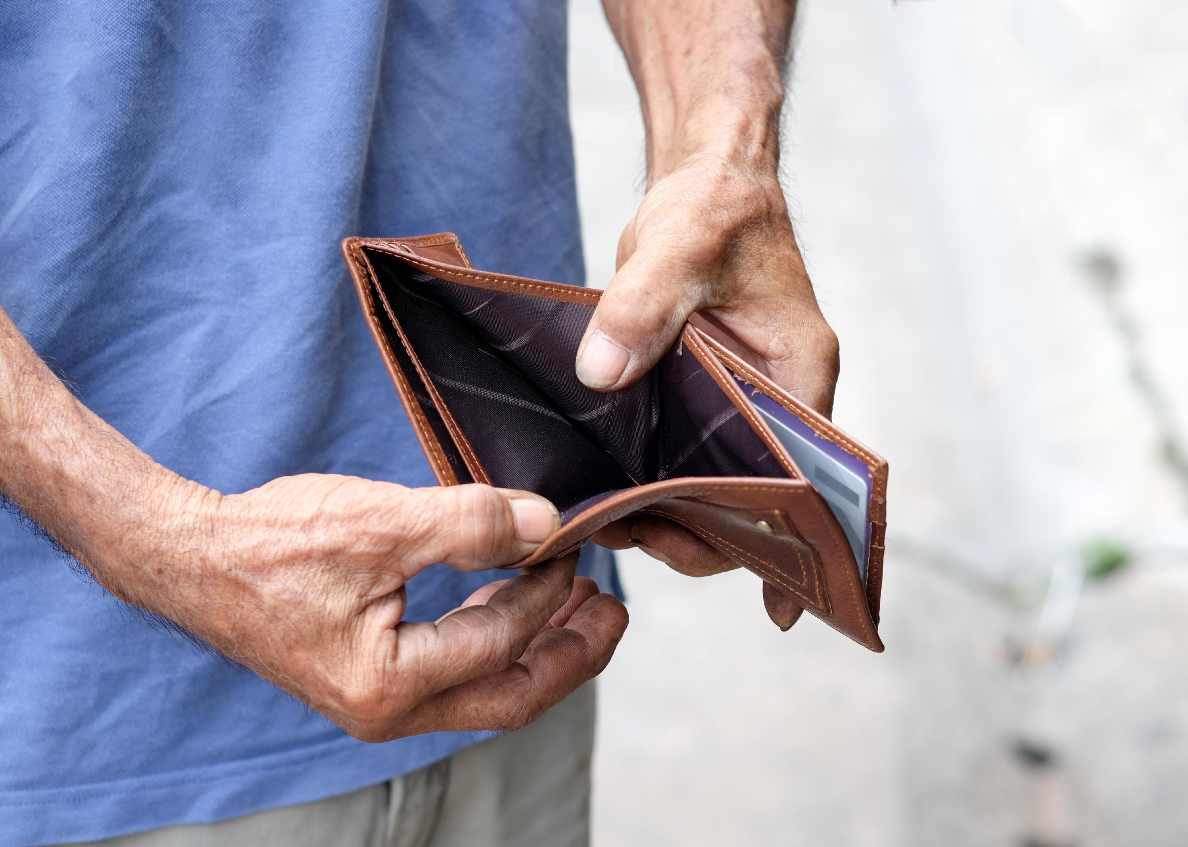 Close up shot of person opening empty wallet.