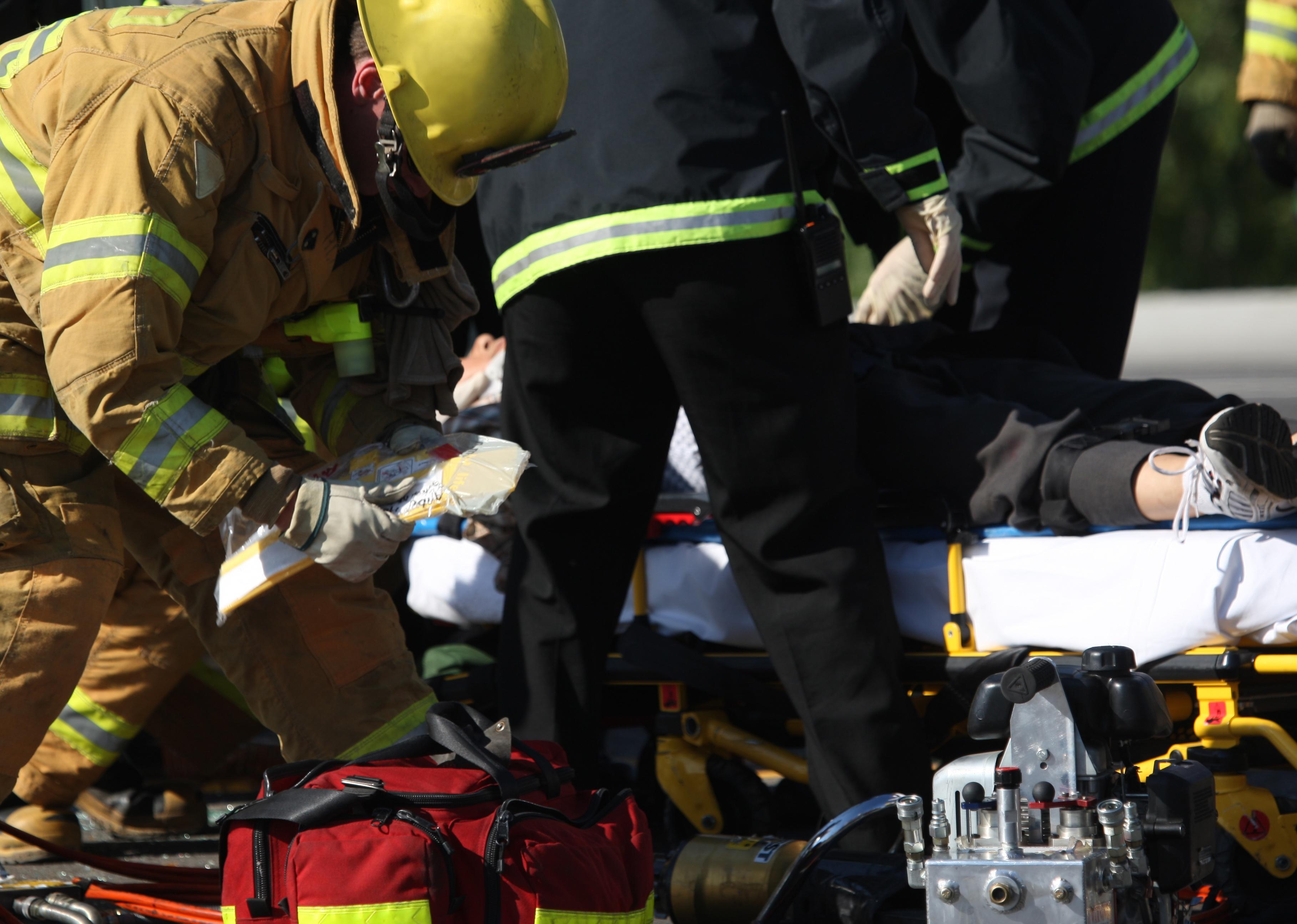 Emergency crew removing a victim from a car accident.