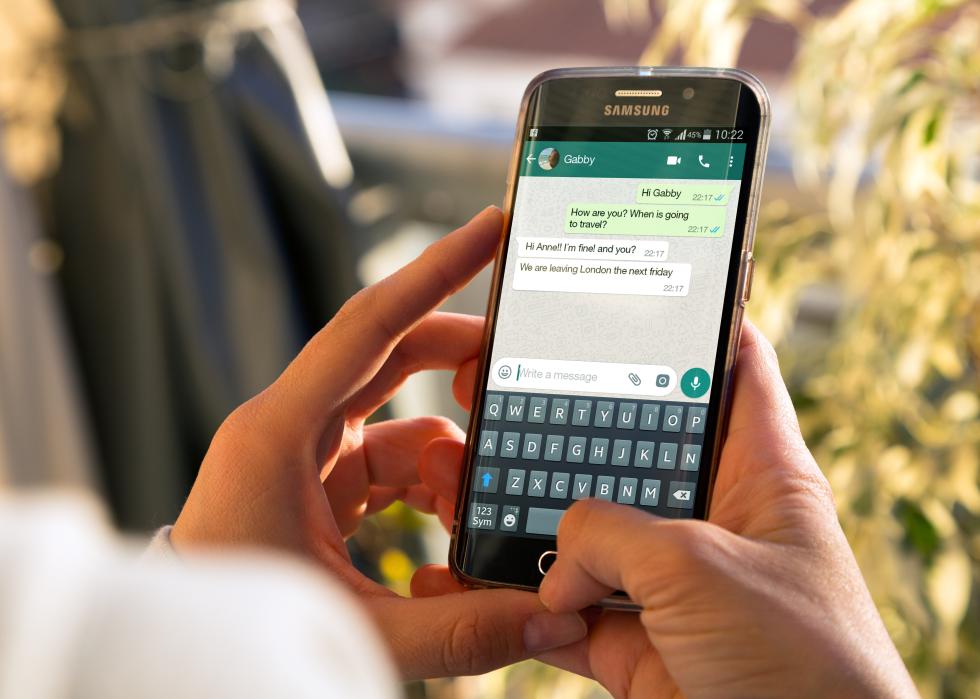 A person messaging on Whatsapp on their smartphone.