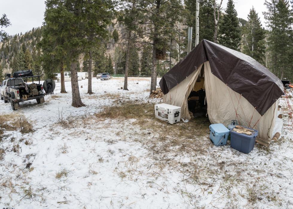 A tent covered with a tarp on a campsite in the Beaverhead-Deerlodge National Forest.