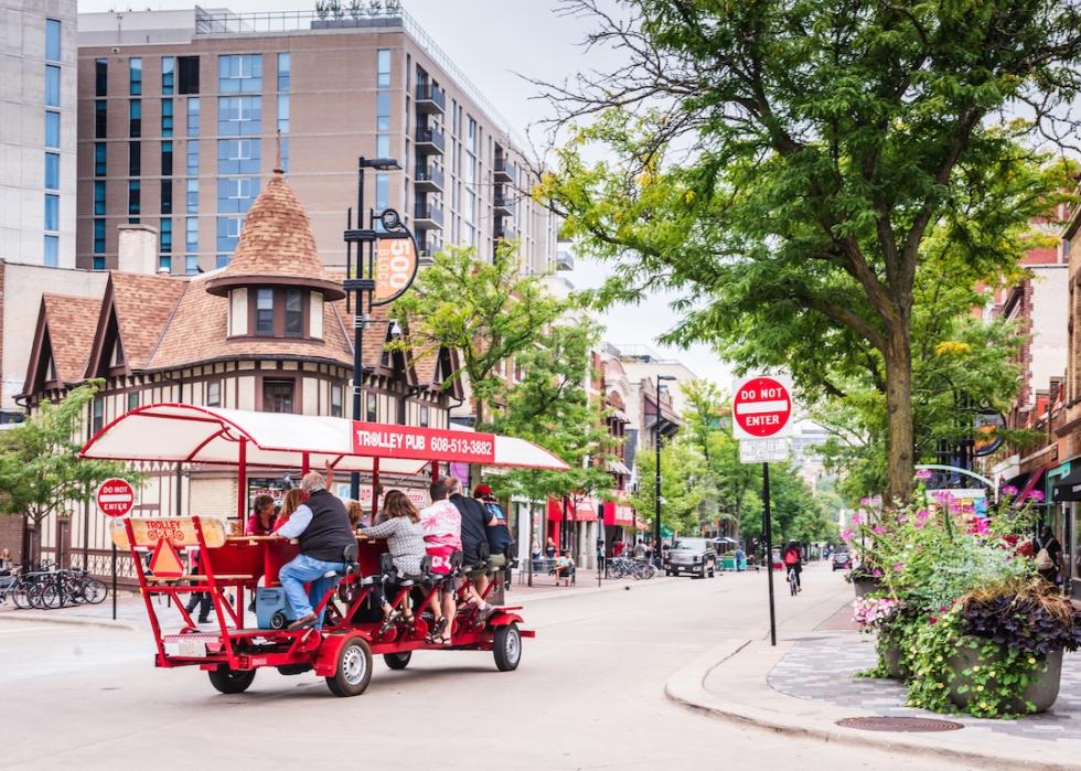 Trolley Pub filled with passengers turning the corner on State Street in Madison, Wisconsin.