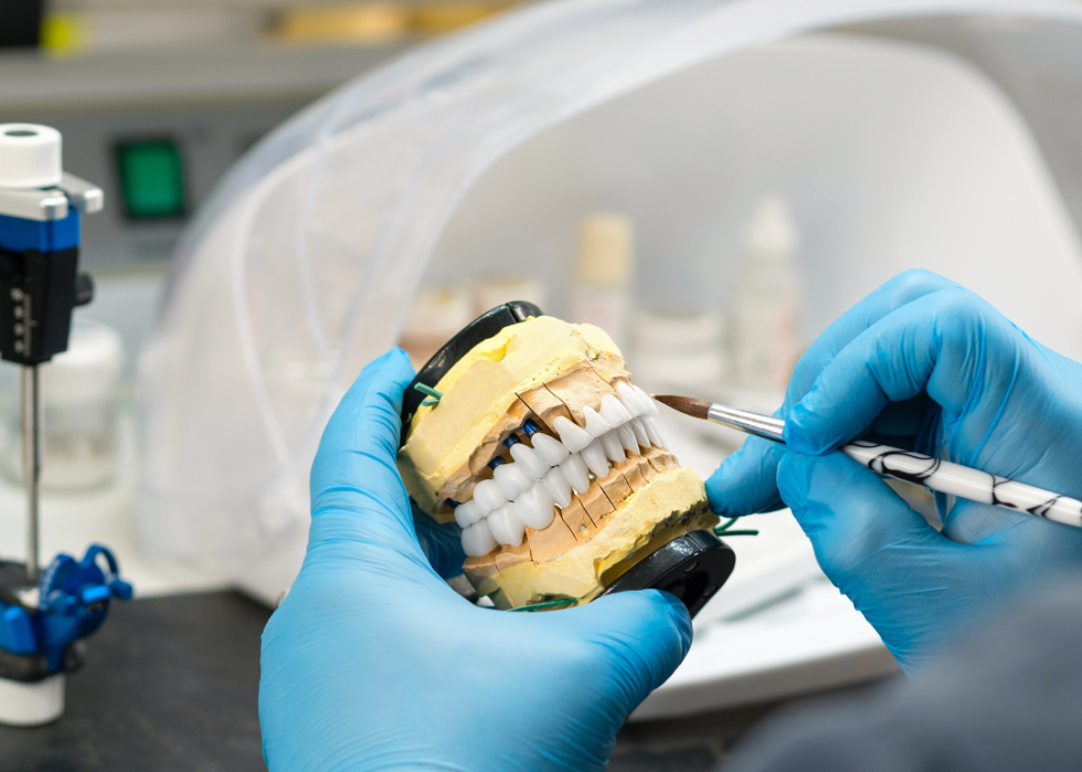 A prosthodontist working on dentures.