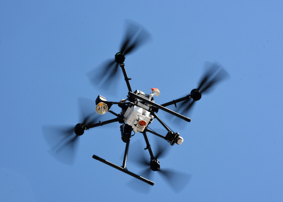 A drone in mid-flight making a delivery.