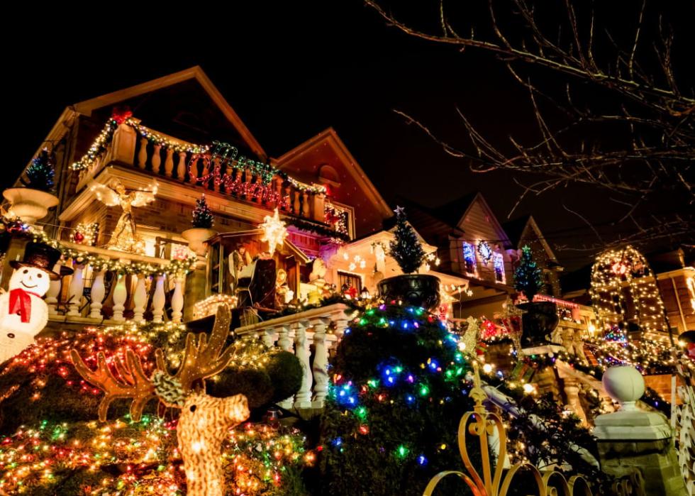 Houses along a street in Dyker Heights with colorful lights.