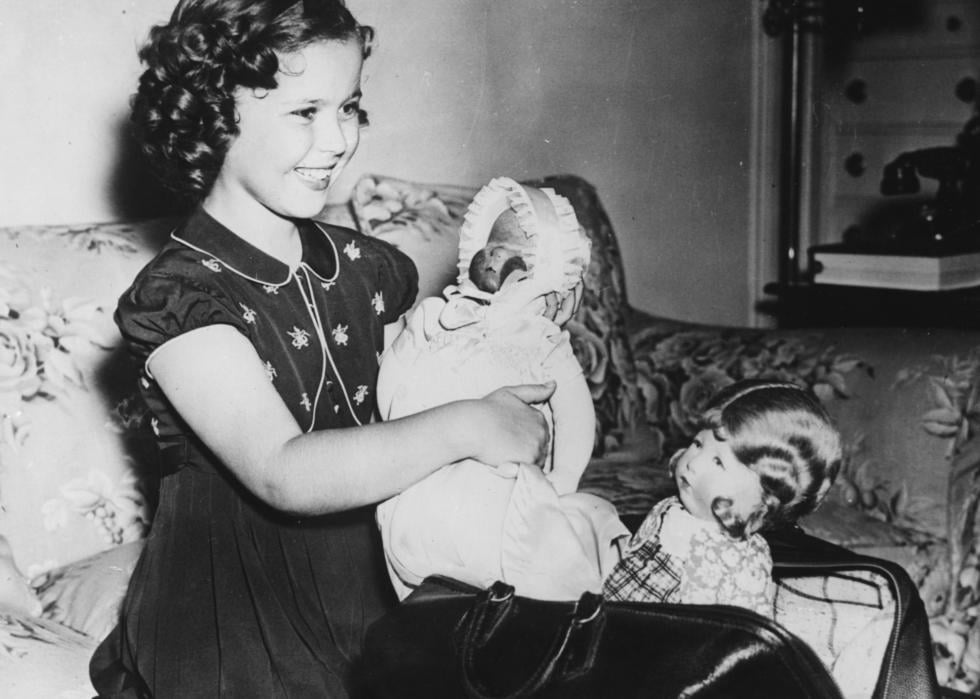 Shirley Temple holding her doll.