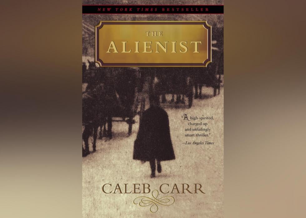 The cover shows a sepia-toned old photo with a silhouette of a cloaked figure walking along side horse-pulled carriages. 