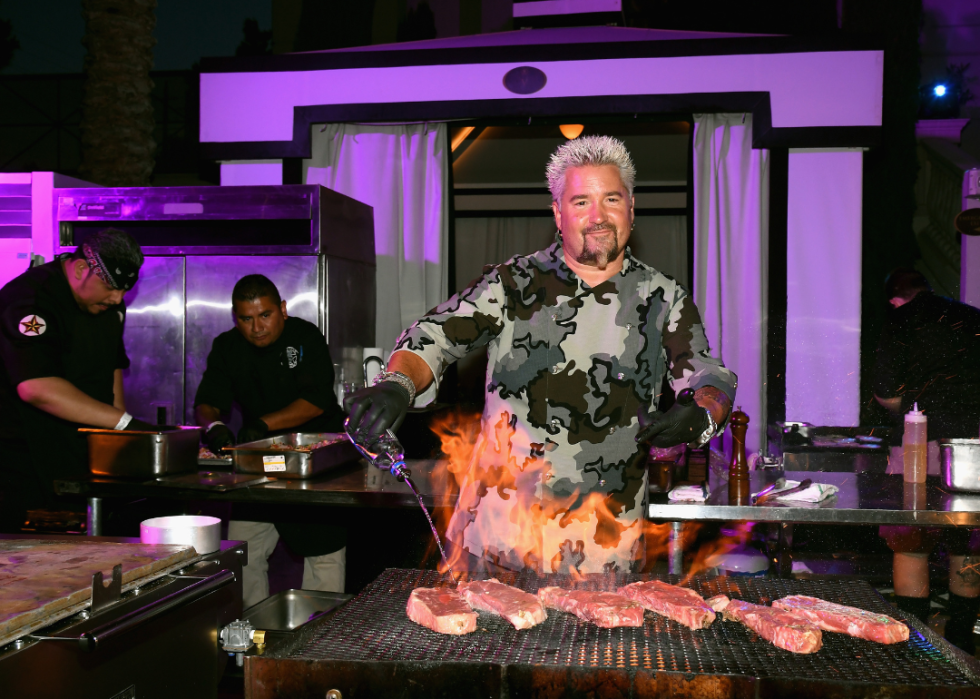 Guy Fieri grilling steaks.