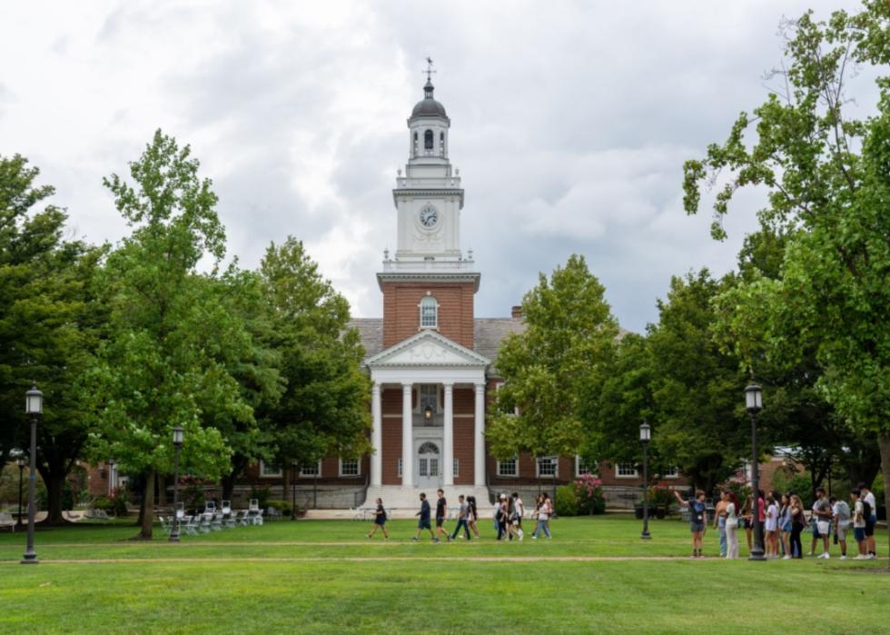 Students walk past Gilman Hall on the Johns Hopkins University campus.