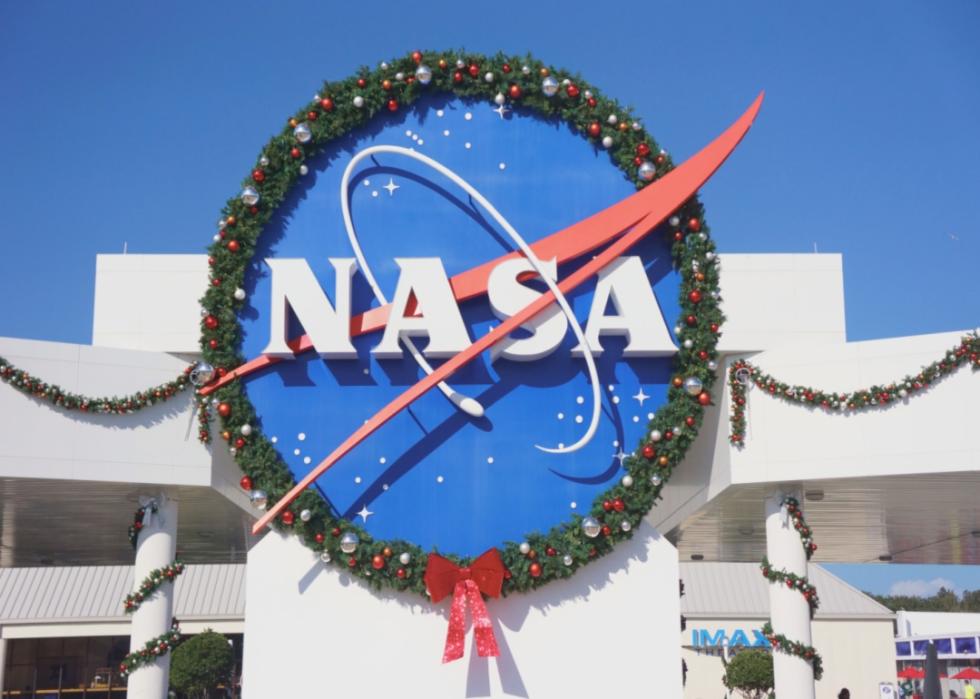 The NASA sign decorated for Christmas with a wreath.