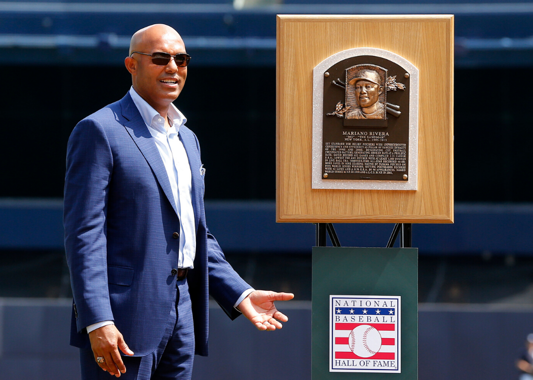 Mariano Rivera stands with his National Baseball Hall of Fame plaque.