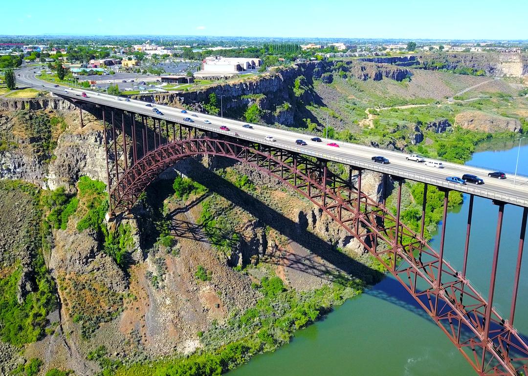 A distant aerial view over River Canyon as cars cross over Perrine Bridge in Twin Falls.