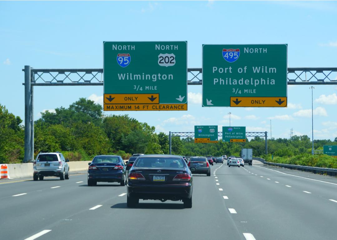 Highway signs and cars driving on Interstate 95 in Wilmington, Delaware.